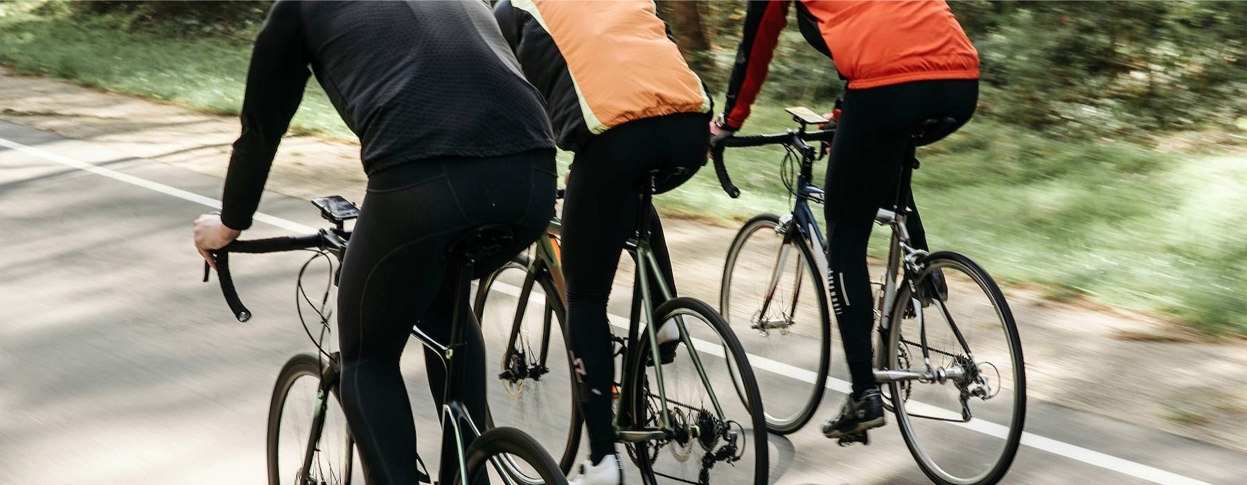 three people riding bicycles
